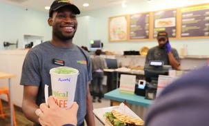 Employee handing a guest a smoothie
